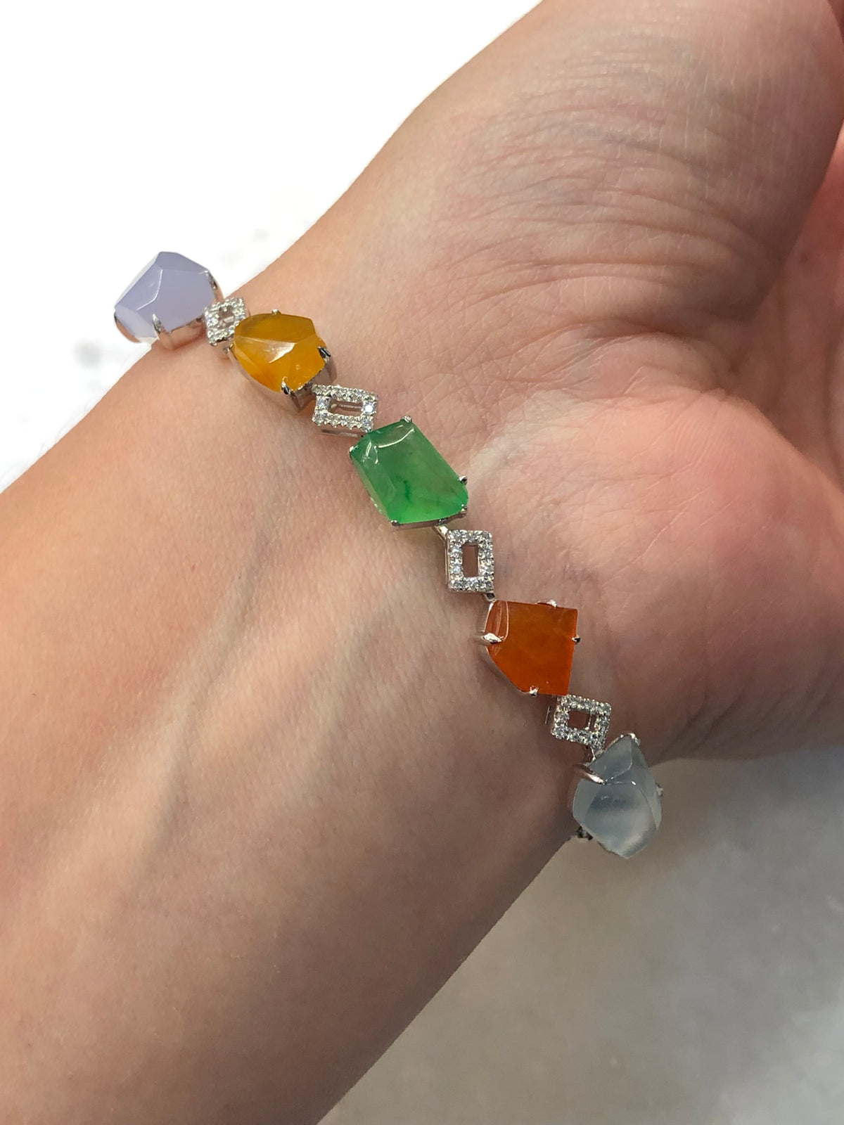 Multi-coloured natural Type A faceted jadeite bracelet featuring green, orange-red, yellow, lavender and icy white jade with diamond-set geometric links in 18K white gold.