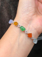 Multi-coloured natural Type A faceted jadeite bracelet featuring green, orange-red, yellow, lavender and icy white jade with diamond-set geometric links in 18K white gold.